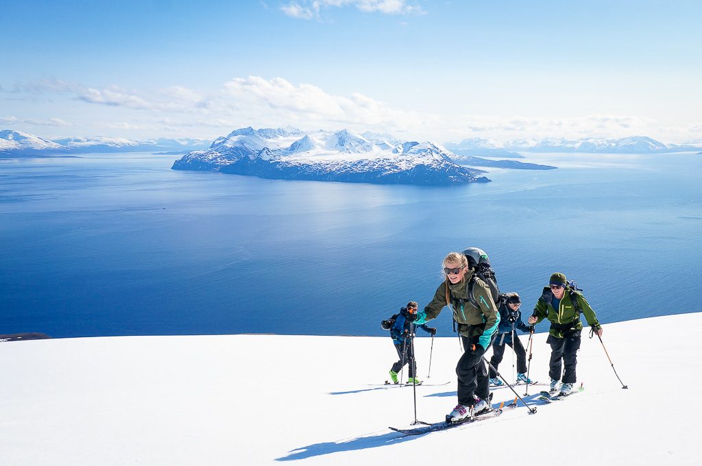 The Lyngen alps in the back when ski touring on the classic Trolltinden at Arnøya. All groups get a day with our boat accessed ski touring included in our Lyngen ski weeks.